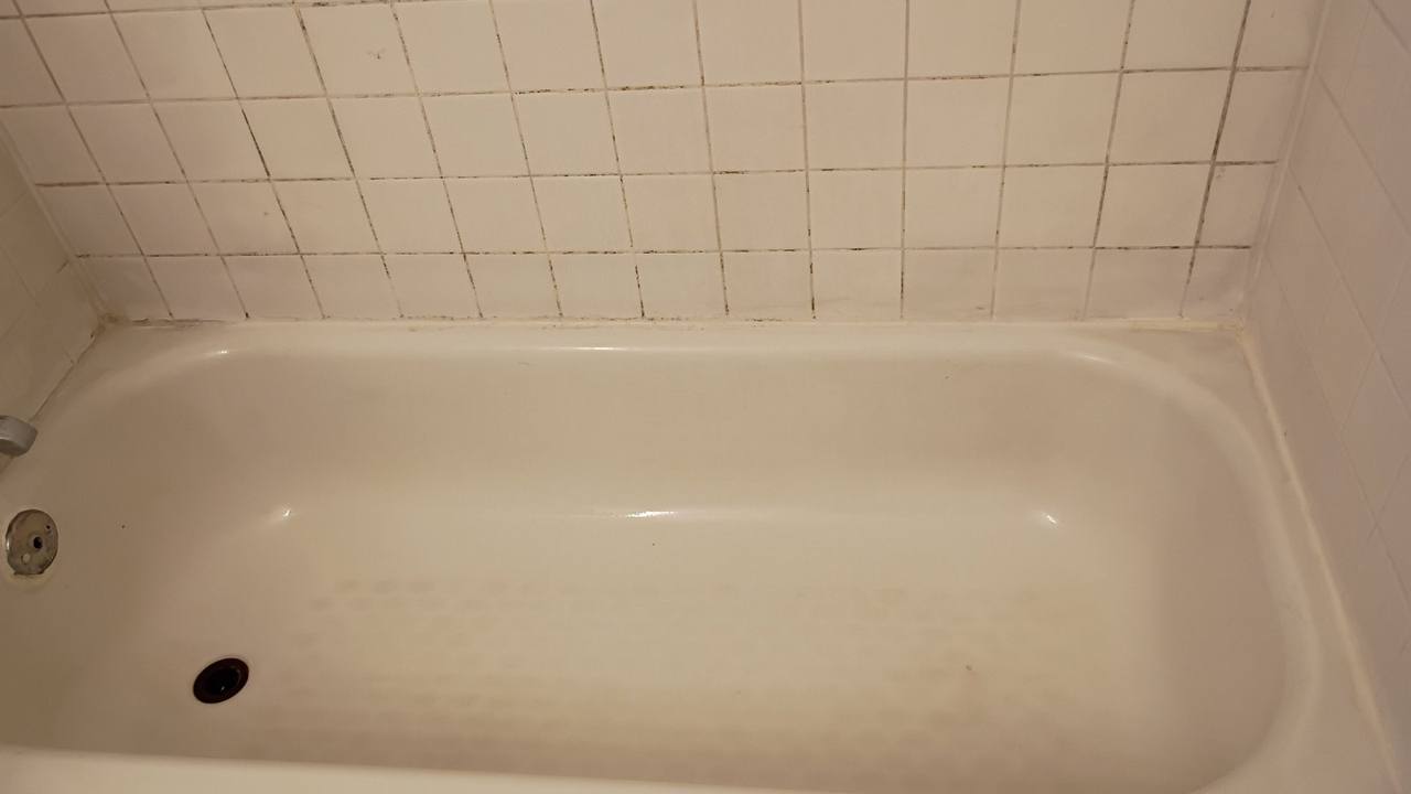 Clean white bathtub and tiles